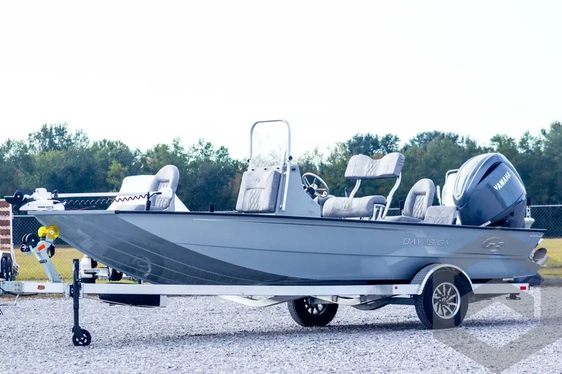 The Image of 2026 G3 Bay 19 GX boat with Yamaha motor on trailer, parked outdoors. - 1