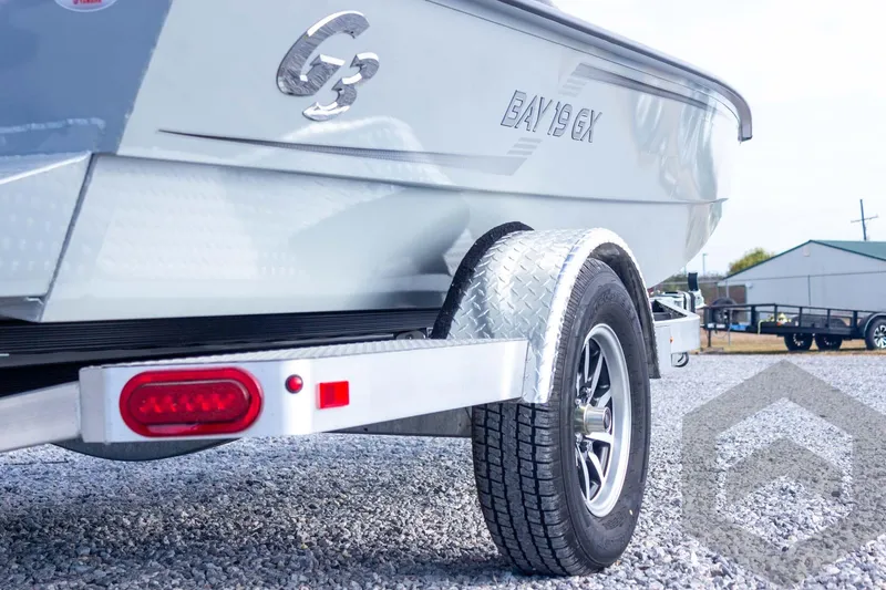 Slide: The Image of 2026 G3 Bay 19 GX boat on trailer, showcasing rear design and tire detail. - 18