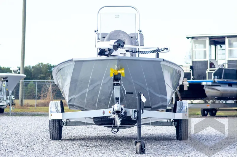 Slide: The Image of 2026 G3 Bay 19 GX boat on trailer, front view, parked on gravel. - 2
