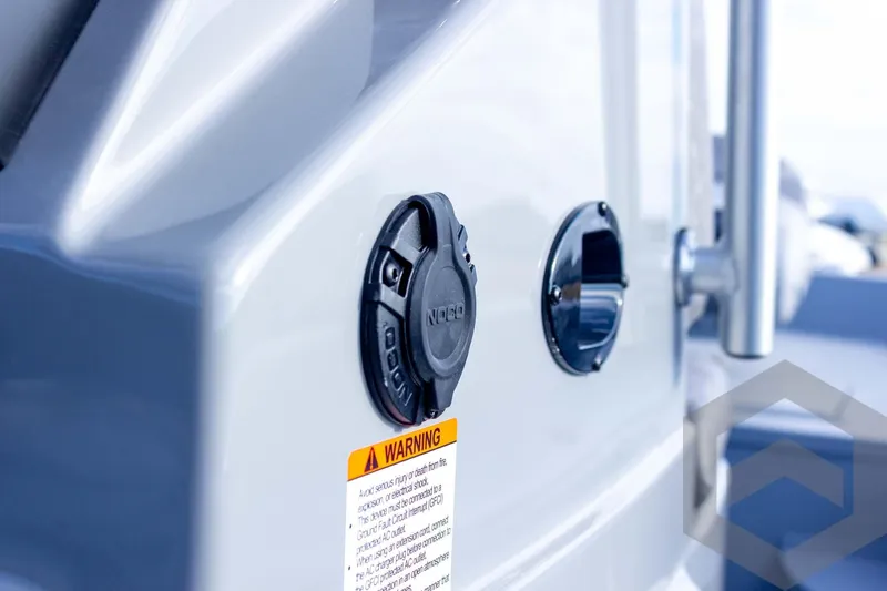Slide: The Image of Close-up of 2026 G3 Bay 19 GX boat's electrical outlet and warning label. - 41