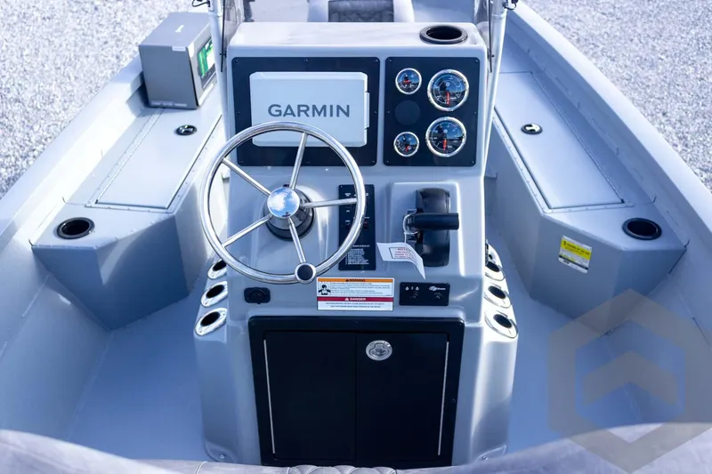 Slide: The Image of 2026 G3 Bay 19 GX boat console with Garmin navigation and steering wheel. - 42