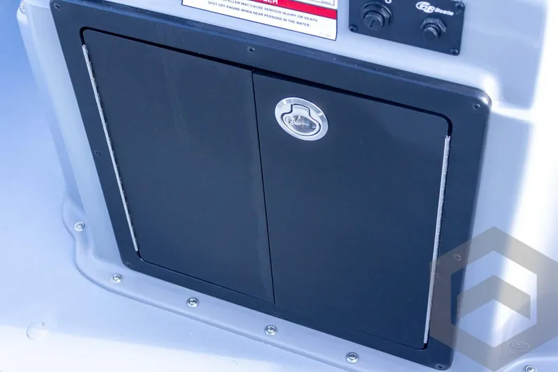 Slide: The Image of 2026 G3 Bay 19 GX boat storage compartment with secure latch and control panel. - 48