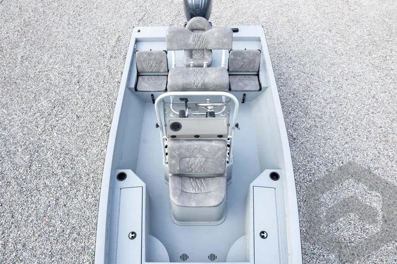 Slide: The Image of 2026 G3 Bay 19 GX boat interior with gray seating and steering console. - 55
