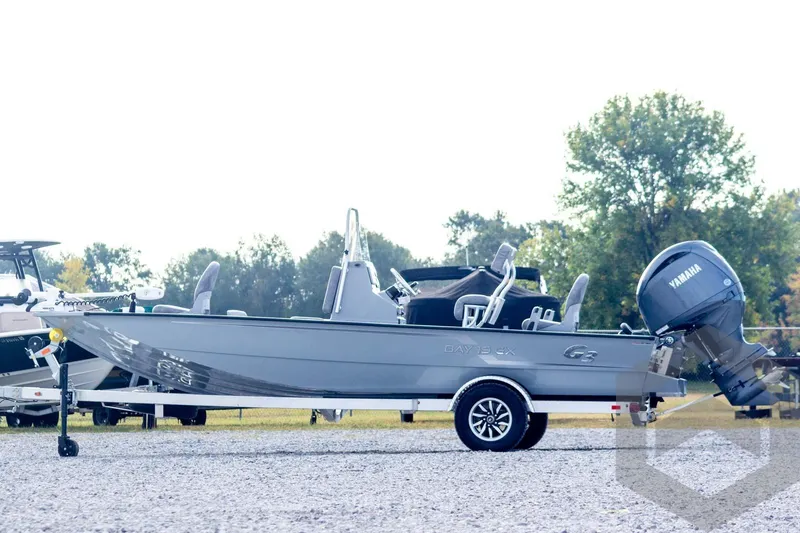 Slide: The Image of 2026 G3 Bay 19 GX boat with Yamaha motor on trailer, parked outdoors. - 6