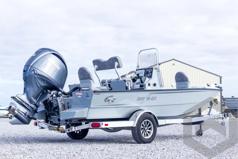 Slide: The Image of 2026 G3 Bay 19 GX boat with Yamaha engine on trailer, parked outdoors. - 8
