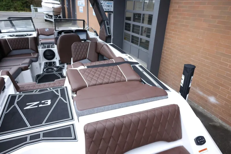 Slide: The Image of 2026 Tigé Z3 boat interior with brown quilted seats and modern design. - 10