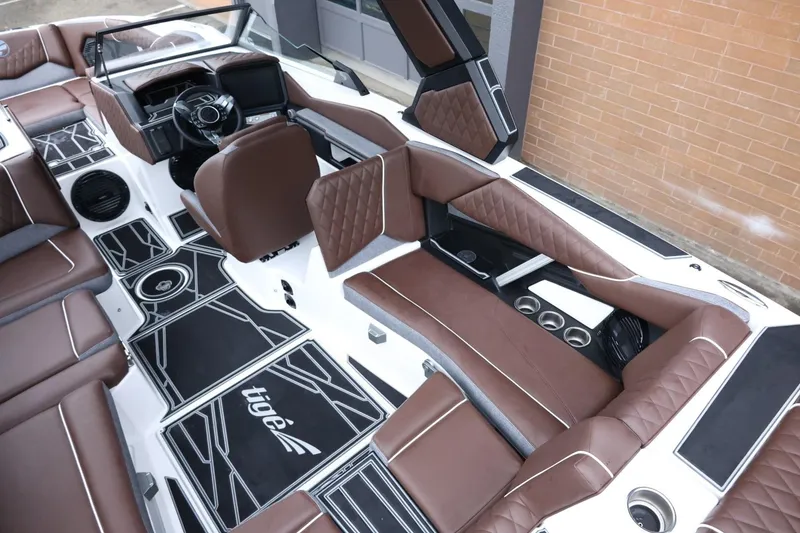 Slide: The Image of 2026 Tigé Z3 boat interior with brown leather seats and modern dashboard design. - 13