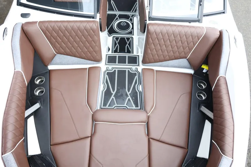 Slide: The Image of 2026 Tigé Z3 boat interior with brown diamond-stitched seating and cup holders. - 18