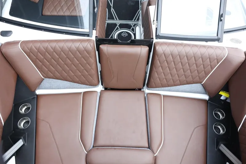 Slide: The Image of 2026 Tigé Z3 boat interior with brown quilted leather seating and cup holders. - 19