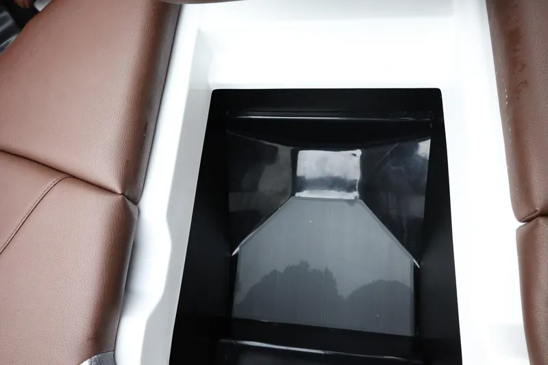 Slide: The Image of 2026 Tigé Z3 boat interior storage compartment with brown leather seats. - 22