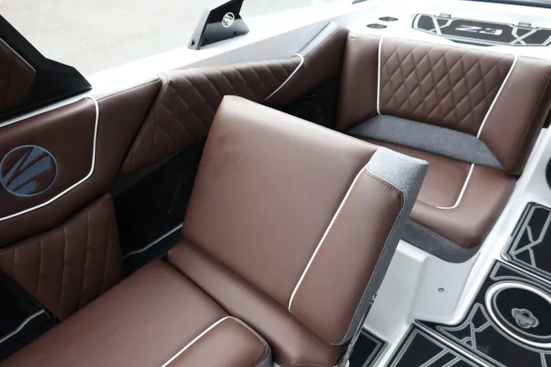 Slide: The Image of 2026 Tigé Z3 boat interior with brown leather seats and diamond stitching. - 25