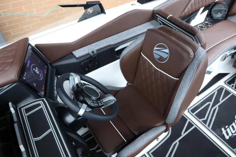 Slide: The Image of 2026 Tigé Z3 boat interior with brown leather seats and modern steering console. - 26