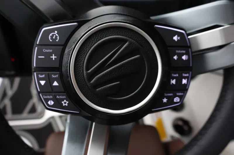Slide: The Image of Steering wheel controls of 2026 Tigé Z3 boat, featuring cruise and audio functions. - 28