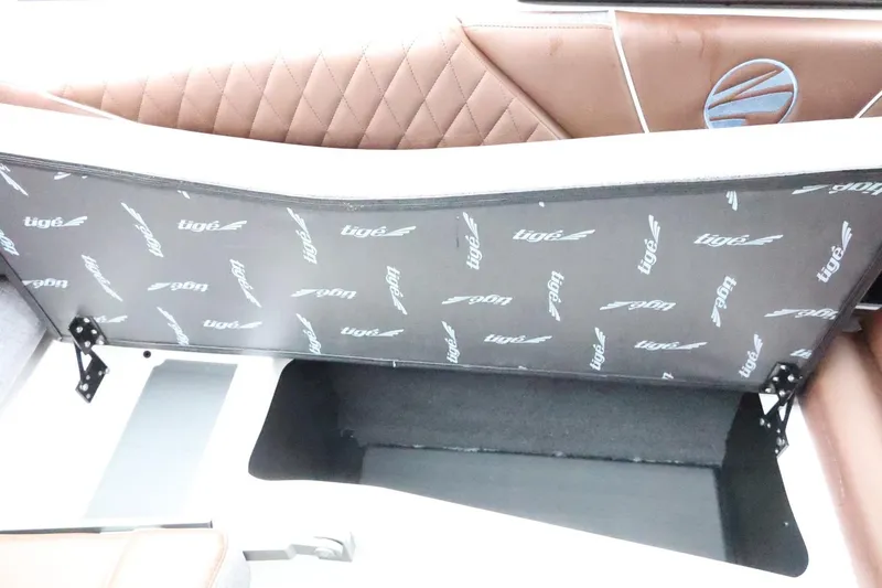 Slide: The Image of 2026 Tigé Z3 boat interior storage compartment with brown quilted upholstery. - 42