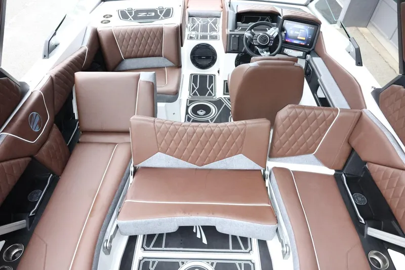 Slide: The Image of 2026 Tigé Z3 boat interior with brown quilted seats and modern dashboard. - 44
