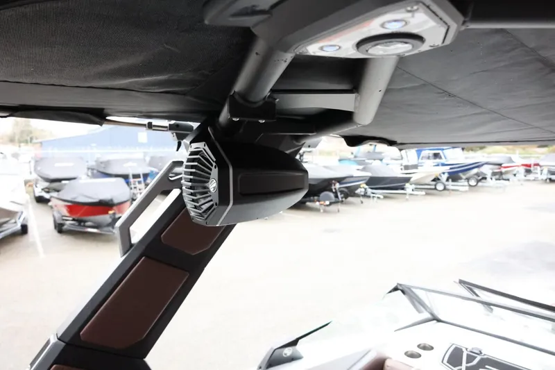 Slide: The Image of 2026 Tigé Z3 boat with mounted speaker and control panel, docked among other boats. - 45