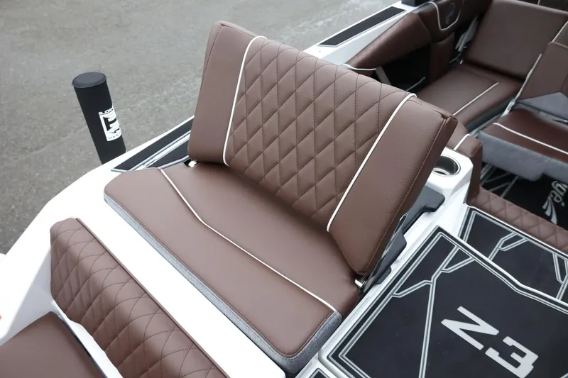 Slide: The Image of 2026 Tigé Z3 boat interior with brown diamond-stitched seating and modern design. - 51