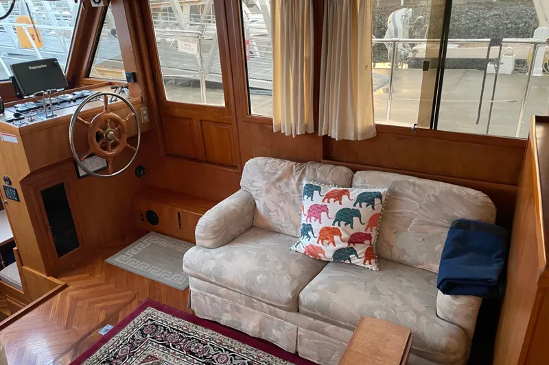 Slide: The Image of Interior of 1985 Nova 40 Sundeck Aft Cabin with sofa and colorful elephant pillow. - 11