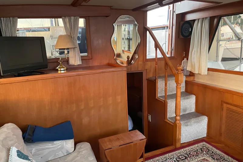 Slide: The Image of Interior of 1985 Nova 40 Sundeck Aft Cabin with TV, lamp, and staircase. - 12