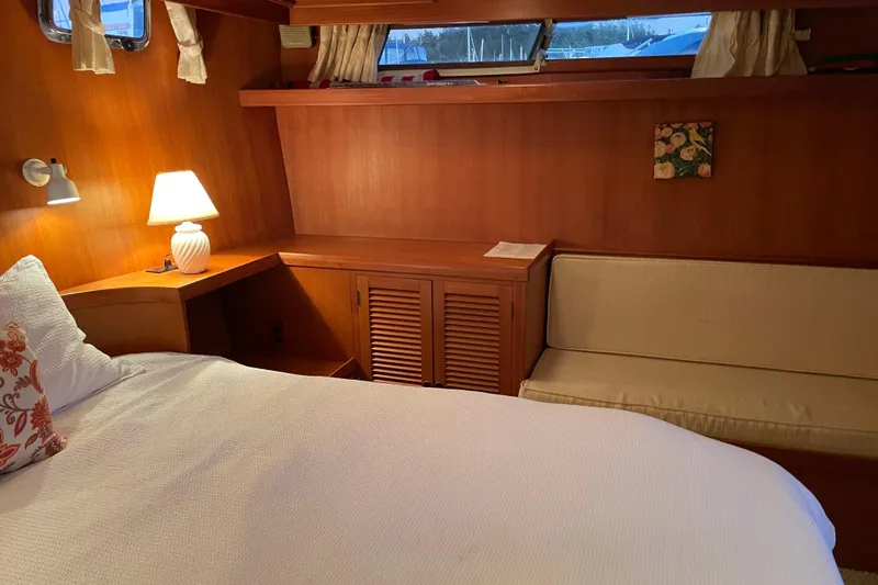 Slide: The Image of Cozy aft cabin interior of 1985 Nova 40 Sundeck with bed, lamp, and seating. - 22