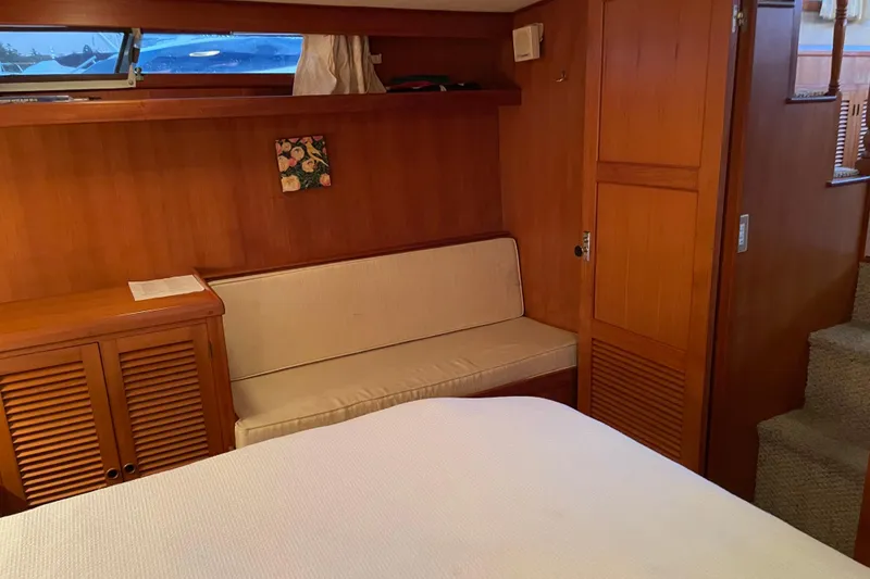 Slide: The Image of 1985 Nova 40 Sundeck Aft Cabin interior with wood paneling and seating area. - 23
