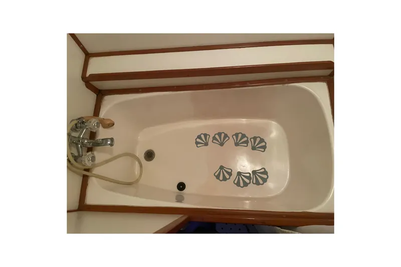 Slide: The Image of Bathtub in 1985 Nova 40 Sundeck Aft Cabin with shell decals and wooden trim. - 26