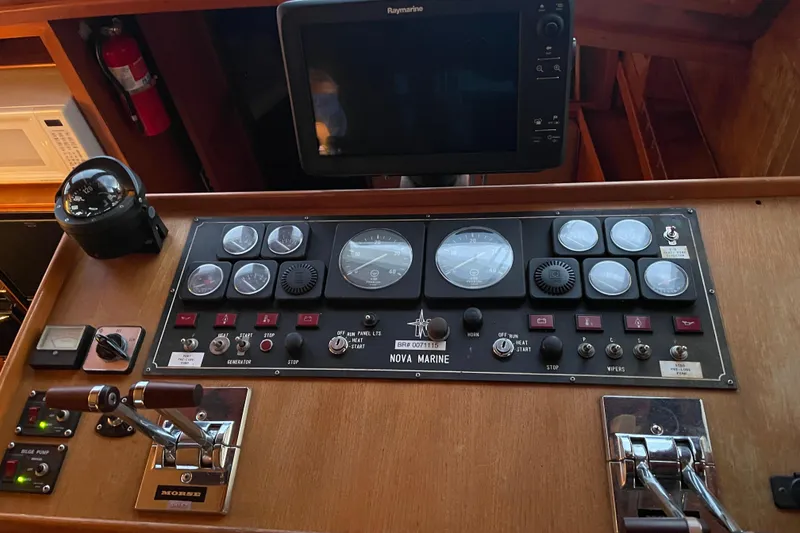 Slide: The Image of Control panel of 1985 Nova 40 Sundeck Aft Cabin with gauges and navigation equipment. - 27