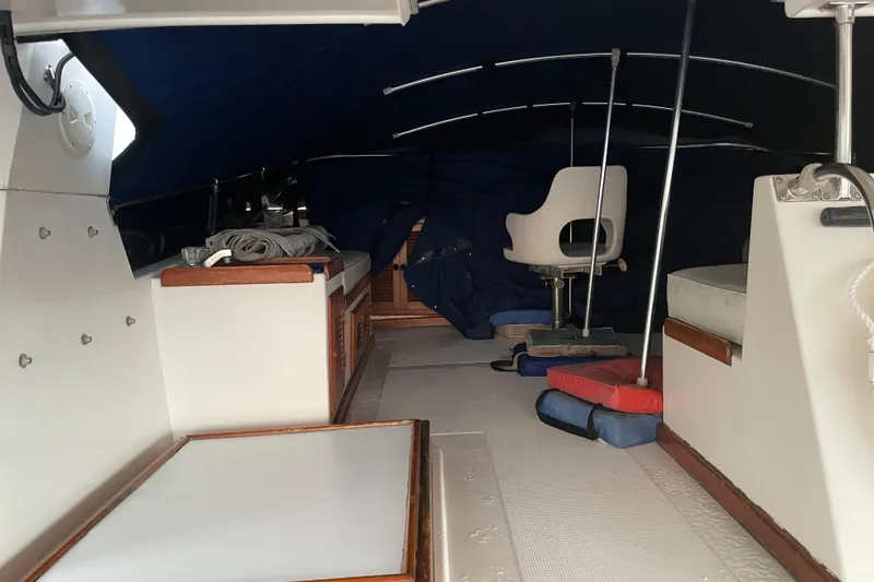 Slide: The Image of 1985 Nova 40 Sundeck Aft Cabin interior with seating and storage under a blue canopy. - 4