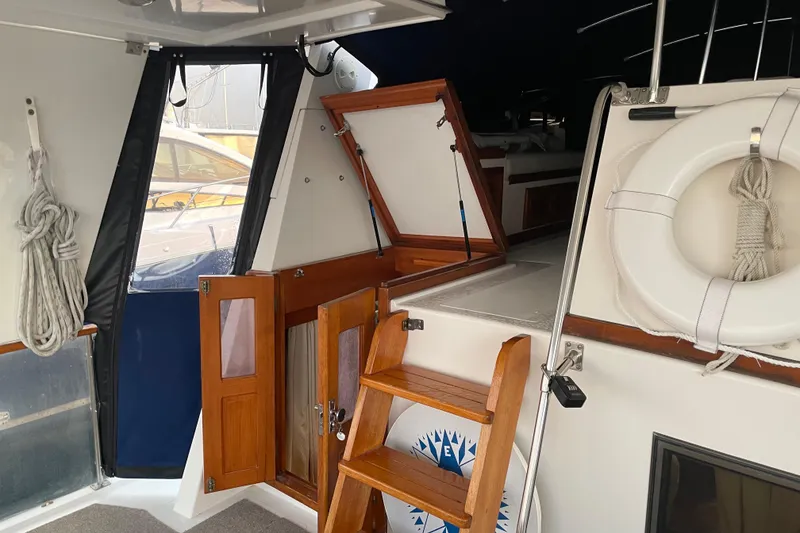 Slide: The Image of 1985 Nova 40 Sundeck Aft Cabin interior with wooden stairs and life preserver. - 9