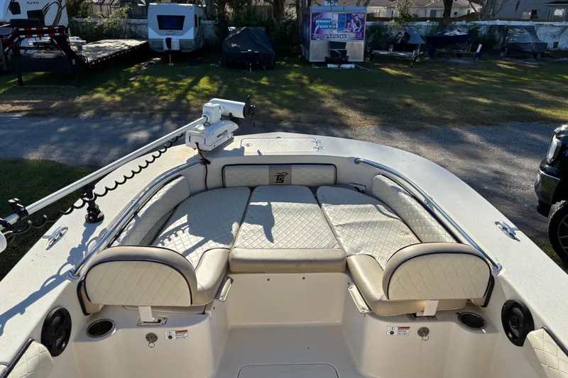 Slide: The Image of 2021 Carolina Skiff 26 Ultra Elite boat with cushioned seating and trolling motor. - 10