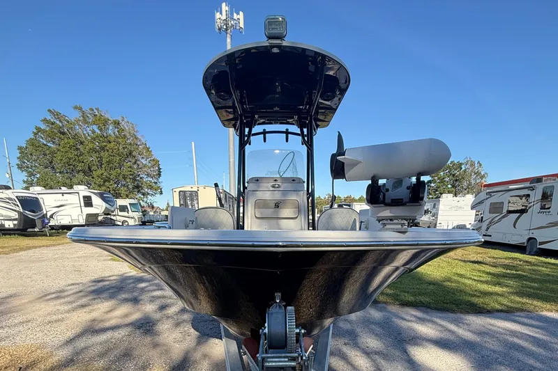 Slide: The Image of 2021 Carolina Skiff 26 Ultra Elite boat on trailer, surrounded by RVs and trees. - 14