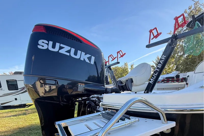 Slide: The Image of 2021 Carolina Skiff 26 Ultra Elite with Suzuki outboard motor and fishing rod holders. - 16