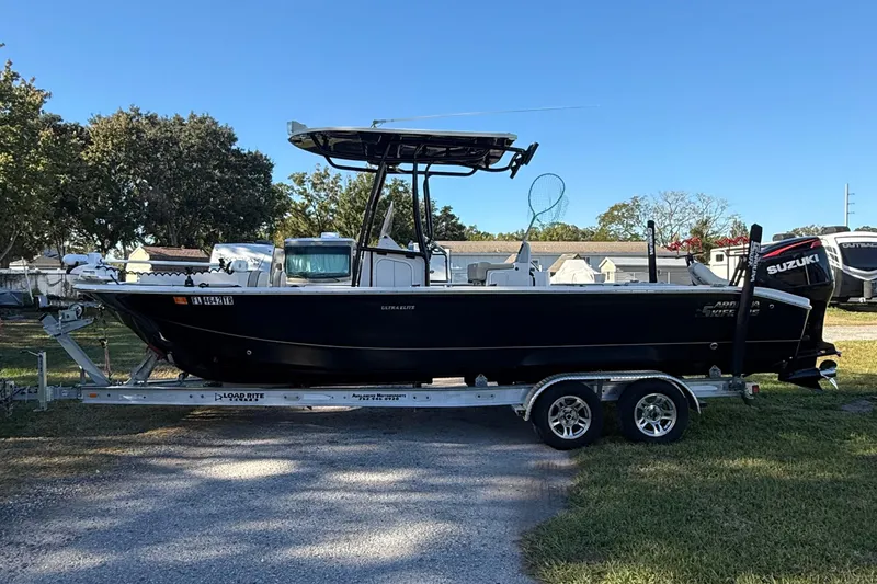 Slide: The Image of 2021 Carolina Skiff 26 Ultra Elite boat on trailer, parked outdoors. - 2