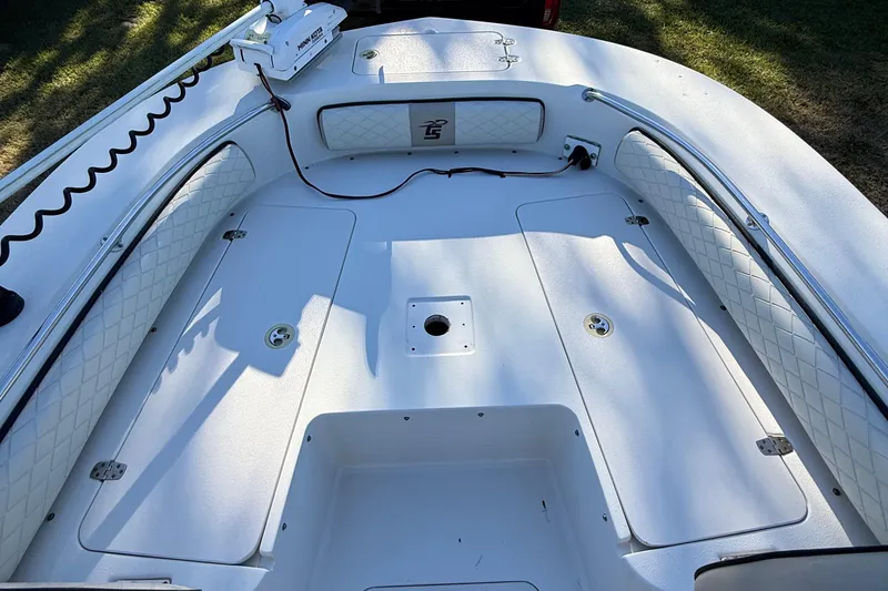 Slide: The Image of 2021 Carolina Skiff 26 Ultra Elite boat interior with cushioned seating and storage compartments. - 30