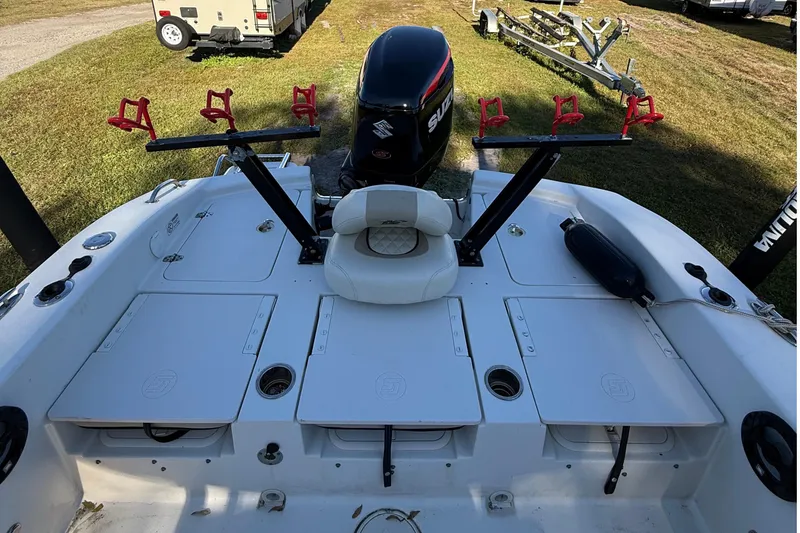 Slide: The Image of 2021 Carolina Skiff 26 Ultra Elite boat with Suzuki outboard motor and rod holders. - 33