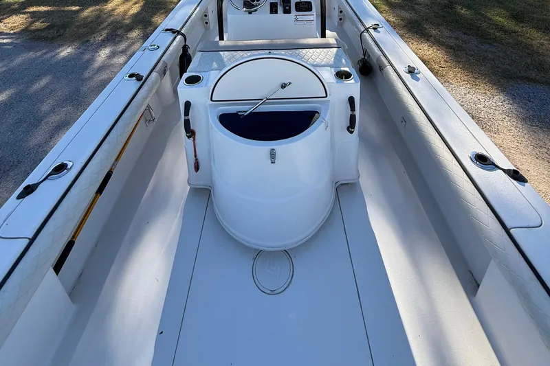 Slide: The Image of 2021 Carolina Skiff 26 Ultra Elite boat interior with center console and rod holders. - 37