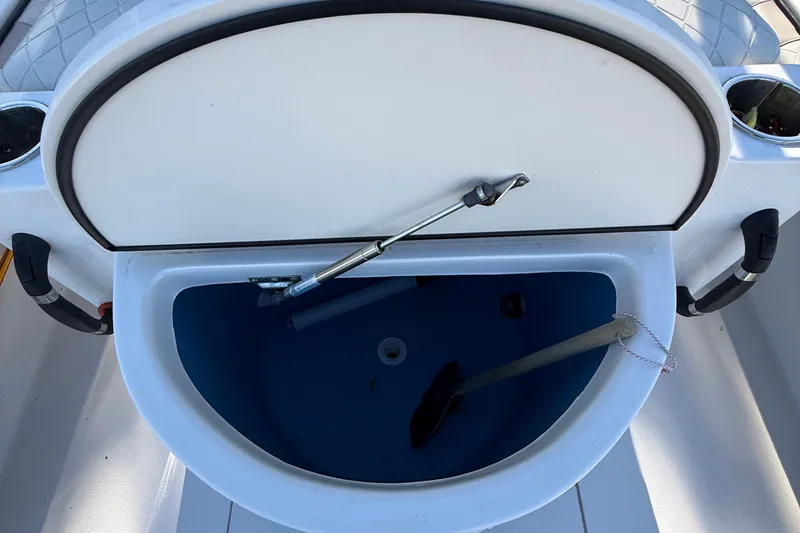 Slide: The Image of 2021 Carolina Skiff 26 Ultra Elite boat storage compartment open. - 39