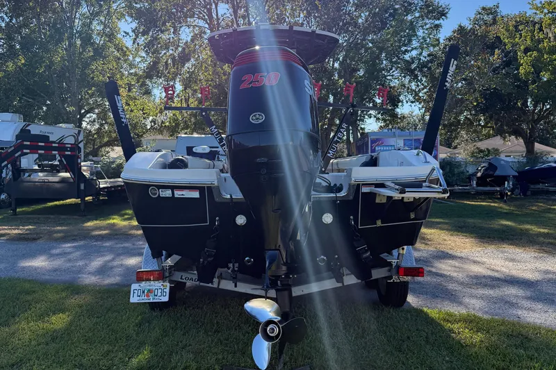 Slide: The Image of 2021 Carolina Skiff 26 Ultra Elite boat with powerful outboard motor in a sunny outdoor setting. - 4