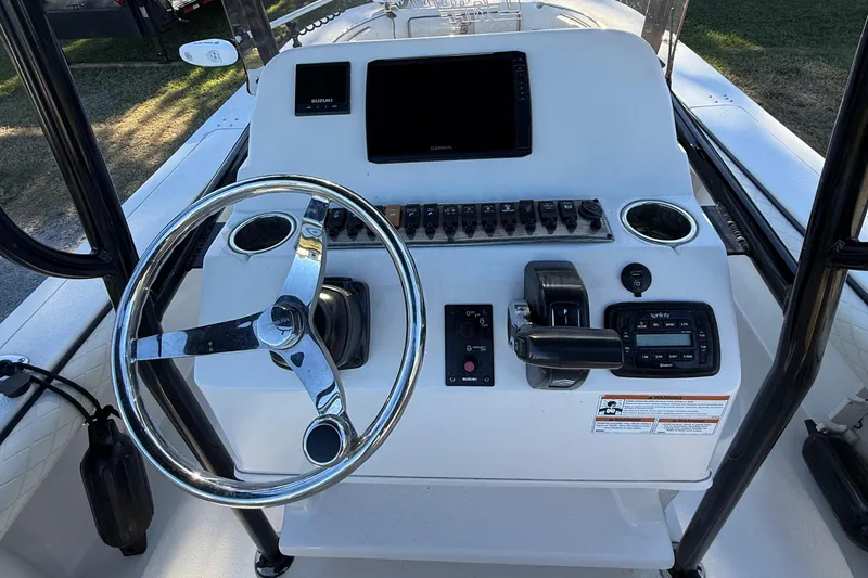 Slide: The Image of Control console of a 2021 Carolina Skiff 26 Ultra Elite boat with steering wheel and electronics. - 41