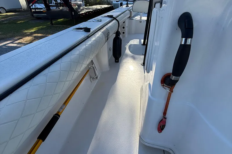 Slide: The Image of 2021 Carolina Skiff 26 Ultra Elite boat interior with rod holder and cushioned side panel. - 44