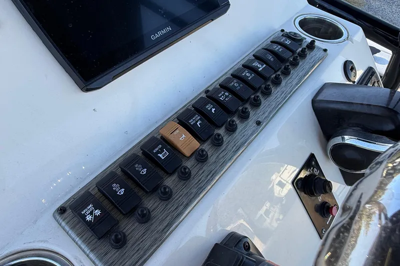 Slide: The Image of Control panel of 2021 Carolina Skiff 26 Ultra Elite boat with switches and Garmin display. - 45