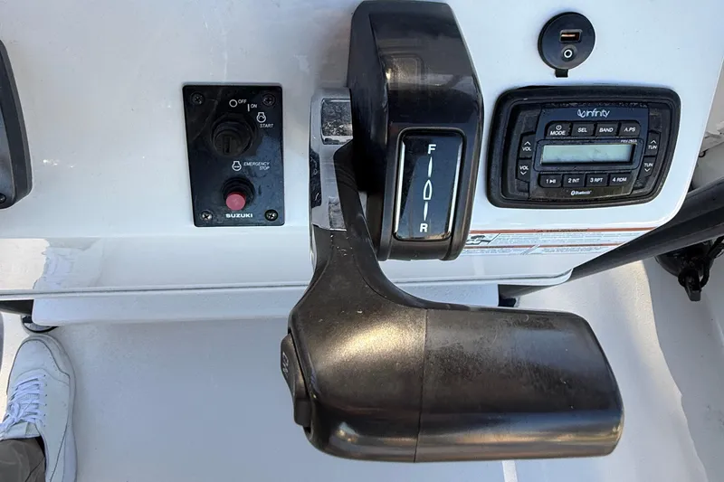 Slide: The Image of Control panel of a 2021 Carolina Skiff 26 Ultra Elite boat with throttle and audio system. - 48