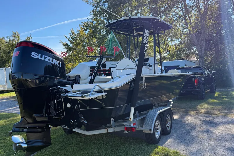 Slide: The Image of 2021 Carolina Skiff 26 Ultra Elite boat with Suzuki engine on trailer. - 5
