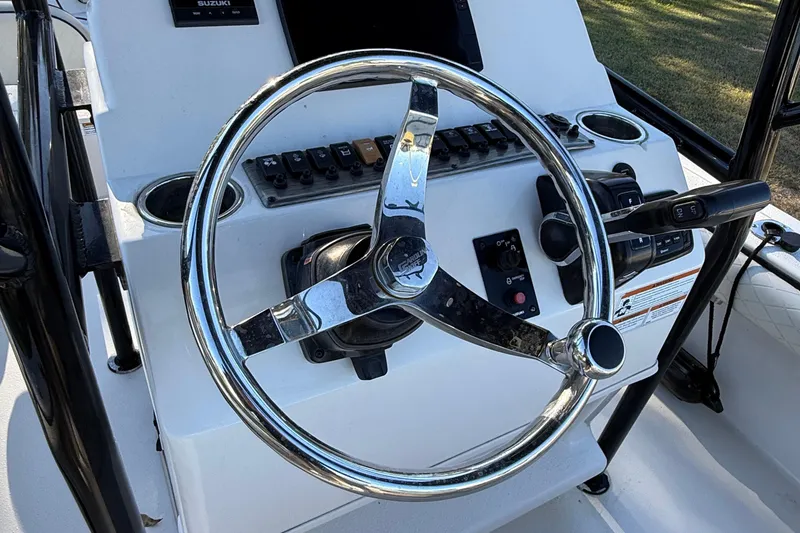 Slide: The Image of Steering console of 2021 Carolina Skiff 26 Ultra Elite boat with controls and switches. - 50