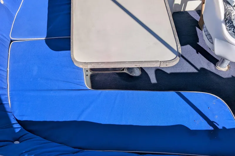 Slide: The Image of Interior of 1989 Duffy 20 boat with blue seating and table. - 12