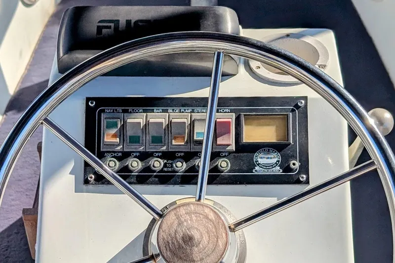 Slide: The Image of Steering wheel and control panel of a 1989 Duffy 20 boat. - 7