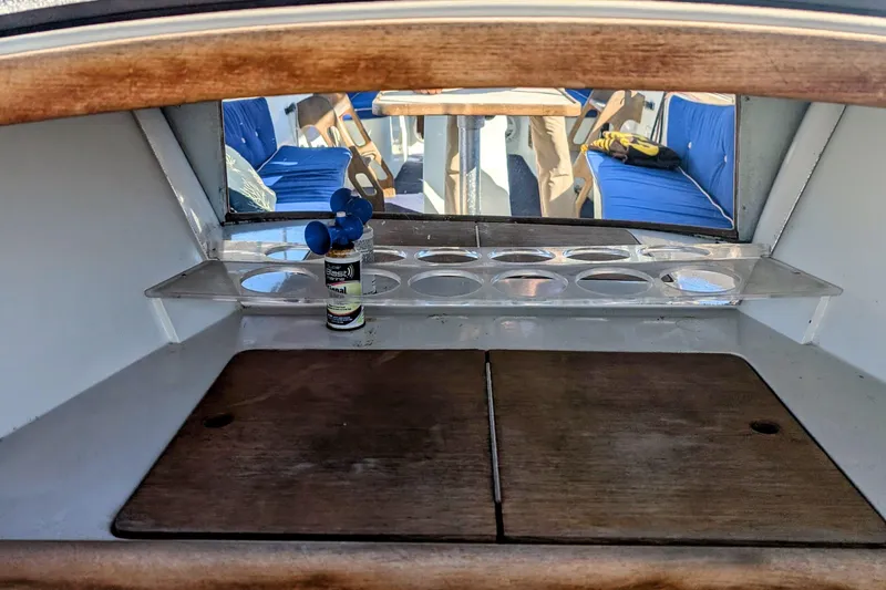 Slide: The Image of Interior of a 1989 Duffy 20 boat with wooden surfaces and blue seating. - 8