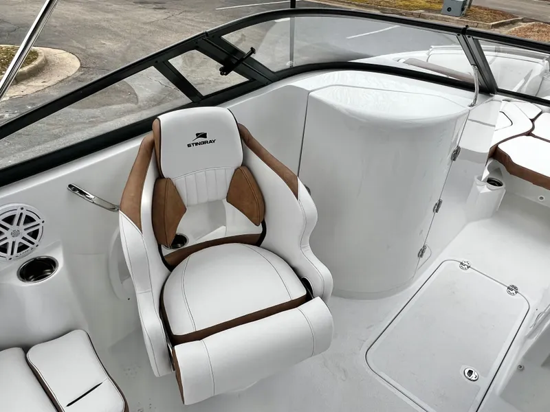 Slide: The Image of Luxurious seating in Stingray 211DC boat, 2026 model, featuring elegant white and brown design. - 12