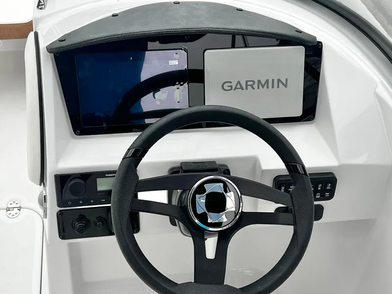 Slide: The Image of Steering wheel and Garmin display on Stingray 211DC boat, 2026 model. - 14