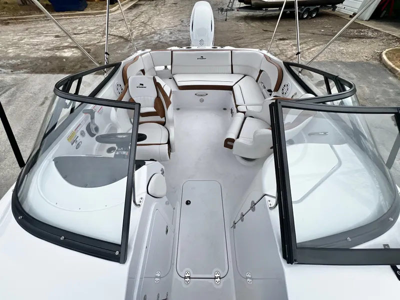 Slide: The Image of Interior view of 2026 Stingray 211DC boat, white seating, in stock. - 18